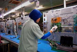 Worker in factory - source ILO