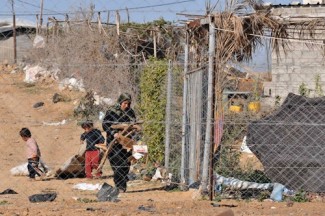 Gaza family collects wood - source UNRWA